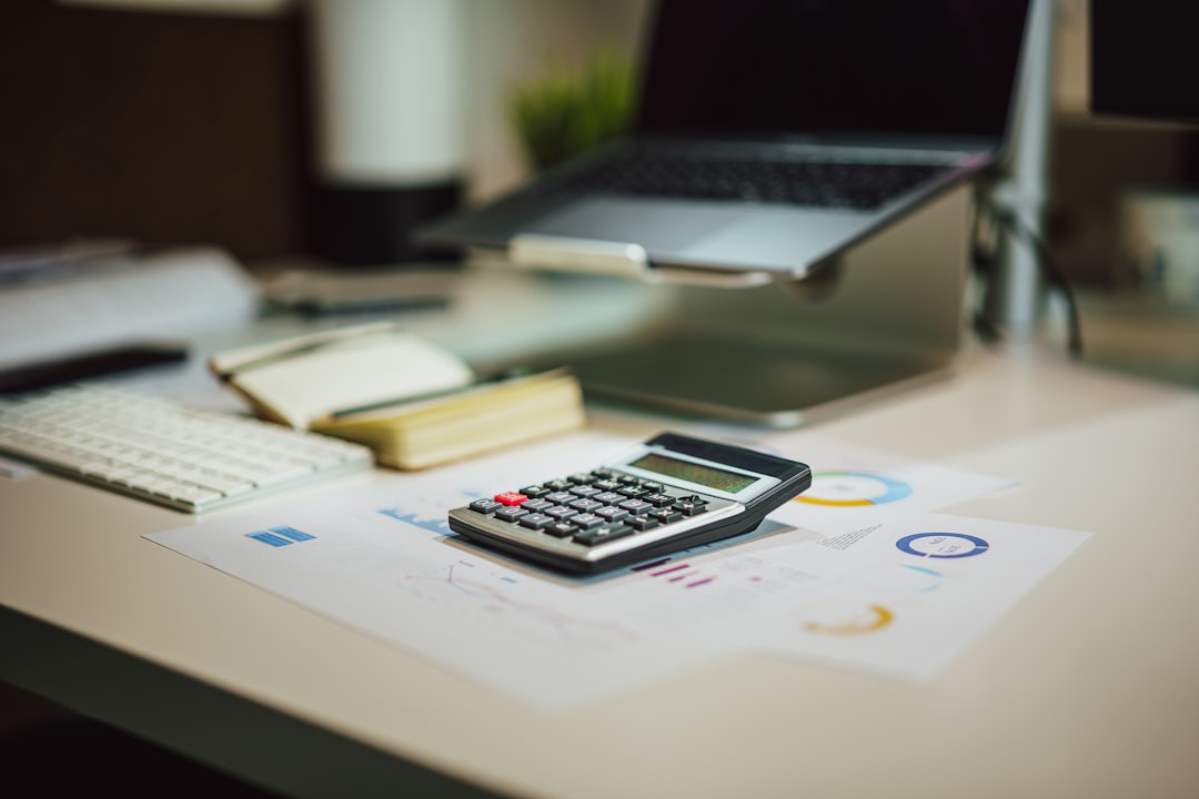 Planning an affordable small business website budget with a laptop and calculator