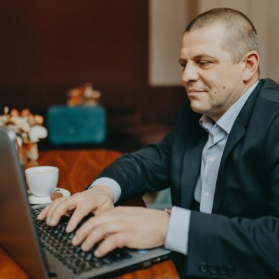 Small business owner working on a laptop while planning a modern website for AI-powered search